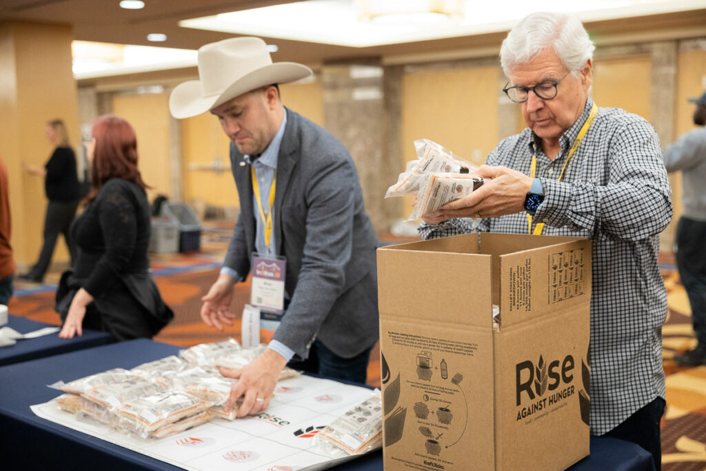 Volunteers at a charity event package meals for hunger relief.